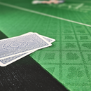 cards on a green black part of a poker table