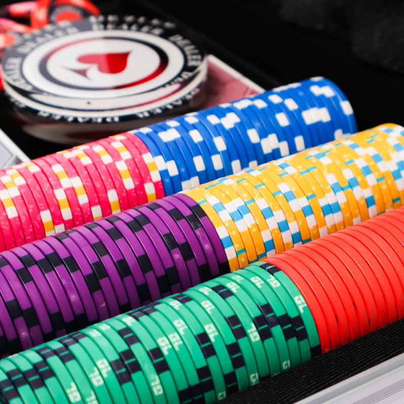 Colorful poker chips on a black surface with a close-up view.