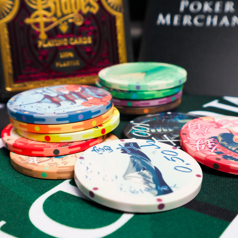 Colorful poker chips on a green felt surface with a card deck in the background.