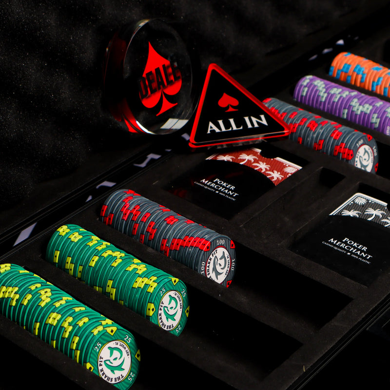 Poker chips with various designs and colors in a display case, featuring branded elements.